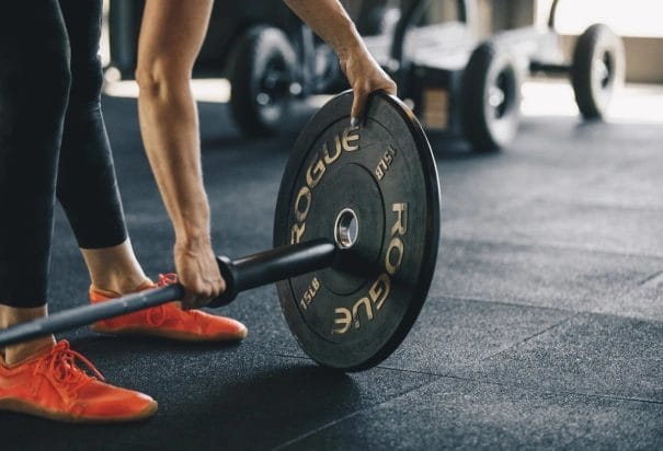 646 Weightlifting Gym Woman Setting Weights on Barbell